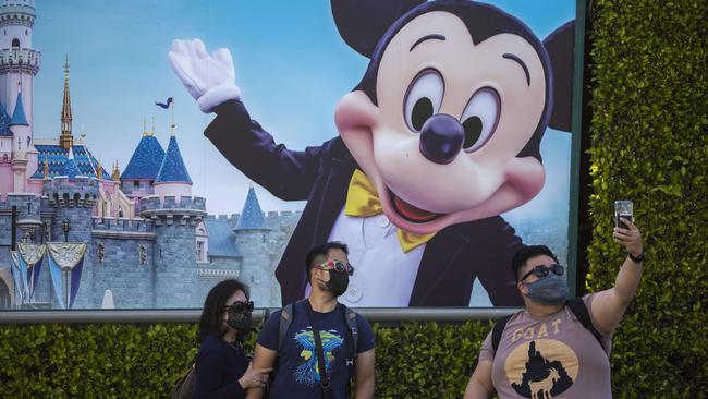 People pose for selfies at Disneyland Park at Anaheim after it reopened recently for the first time since it shut because of the pandemic. Picture: AFP