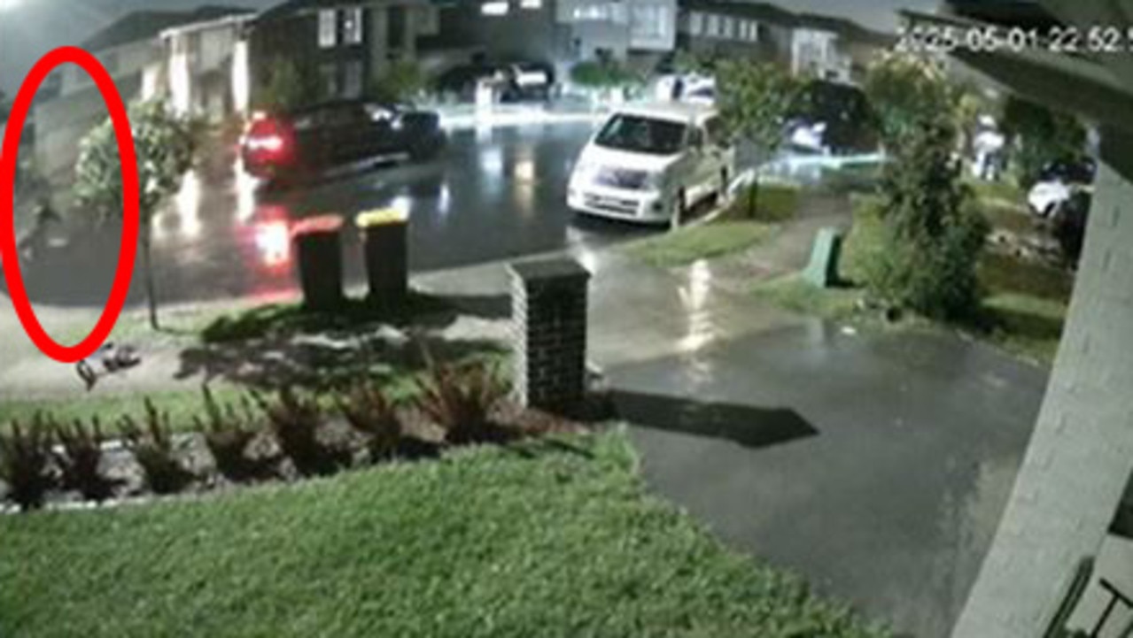 In this CCTV still one of two gunmen, circled, can be seen running back towards a black SUV after a barrage of shots were unleashed on the Marsden Park home. Picture: Supplied