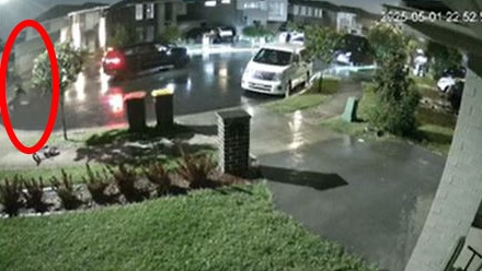 In this CCTV still one of two gunmen, circled, can be seen running back towards a black SUV after a barrage of shots were unleashed on the Marsden Park home. Picture: Supplied