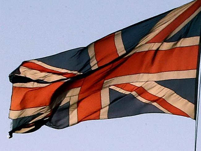 A British Airways passenger aircraft is pictured beyond a Union flag as it flies atop the Victoria Tower at the Houses of Parliamnet in central London on January 28, 2019. - Despite the humiliating rejection of Prime Minister Theresa May's Brexit deal, Britain is no closer to knowing the end result of its vote to leave the European Union. A raft of amendments to be voted on by MPs on Tuesday threaten to further muddy the waters as the clock ticks down to Britain's scheduled departure from the EU on March 29. (Photo by Tolga AKMEN / AFP)