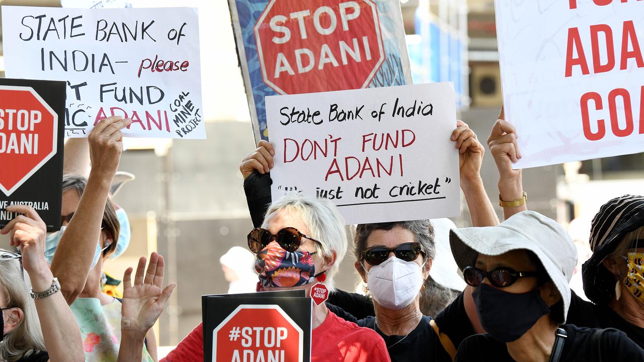 Stop Adani protesters hold placards. Picture: NCA NewsWire/Bianca De Marchi