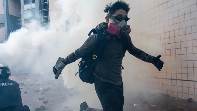 A protester runs from the Hong Kong Polytechnic University yesterday. Picture: Getty Images