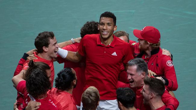 Canada’s Felix Auger Aliassime (centre) celebrates with teammates after winning the Davis Cup final. Picture: AFP