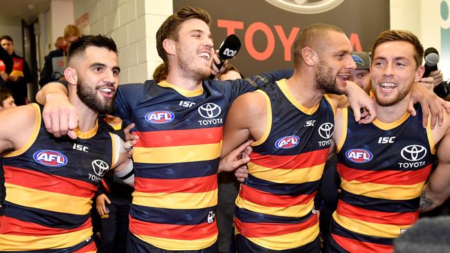 Crows players belt out the club song in the rooms after the win against the GWS Giants. Picture: AAP Image/Sam Wundke