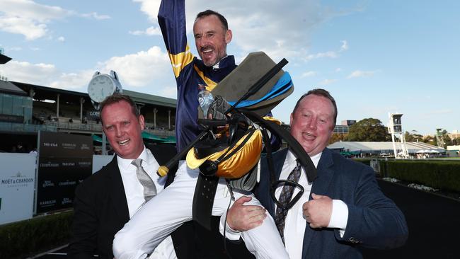 Co-trainers Michael and Wayne Hawkes celebrate with jockey Glen Boss after Brutal’s big win. Picture: Getty Images 