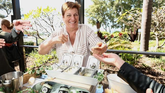 Karen Lindsay in action at her stand the little white goat at the launch of the Moreton Bay Food and Wine Festival. Photo: AAP /Jono Searle