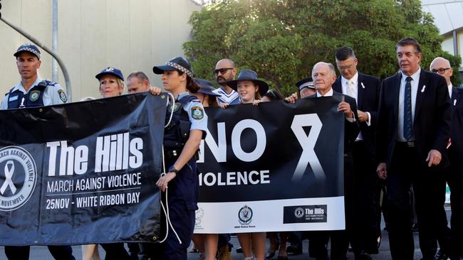 Local police joined politicians, school students and community members to march against violence against women.