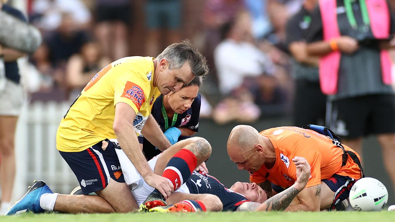 Jake Friend is attended to by Roosters trainers after a head knock suffered against Manly in round 1 at the SCG.