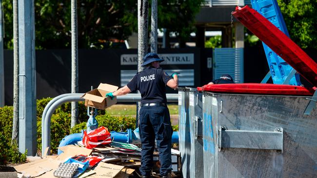 NT look for evidence in bins at the Karama Shopping Centre in connection with an incident in which a young man was fatally stabbed overnight. Picture: Che Chorley