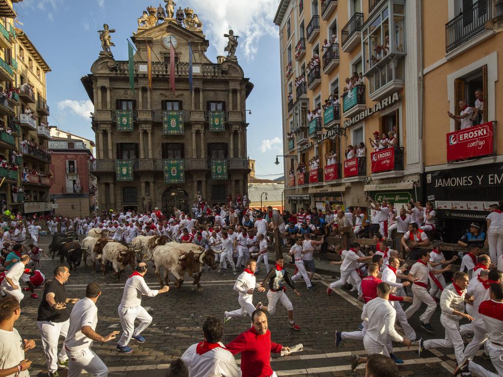 Revellers run with Cebada Gagos's fighting bulls before at Plaza Consistorial. Photo: Pablo Blazquez Dominguez/Getty