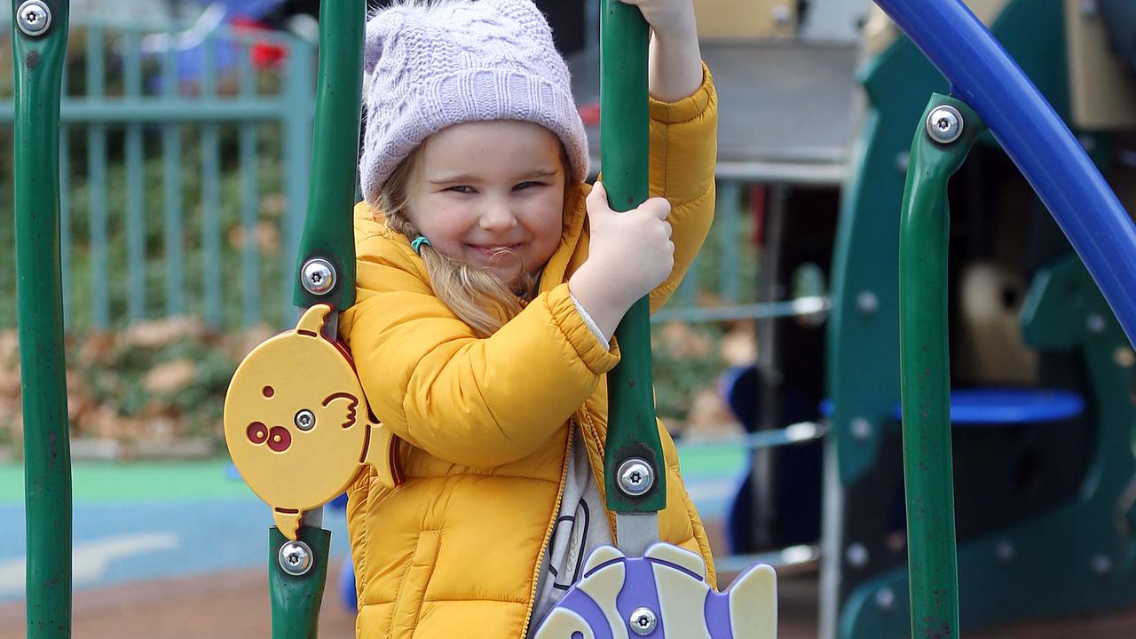 A young girl enjoys being back at the park in Rushcutters Bay.