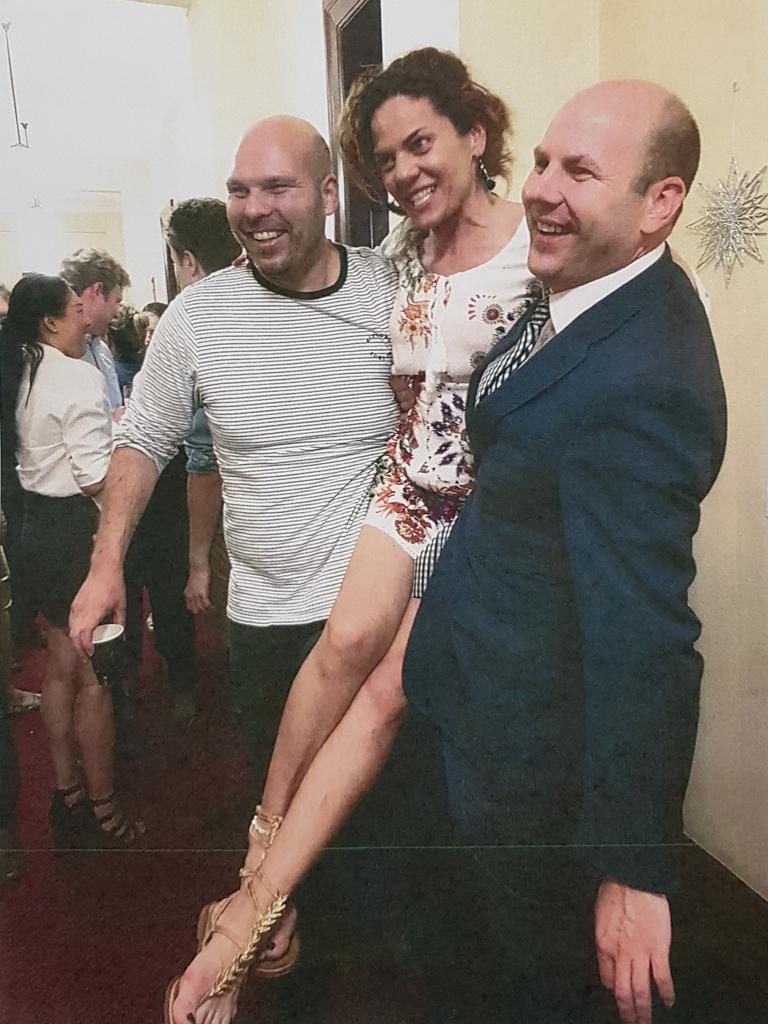 A photo from the night shows MPs Justin Hanson and Mr Duluk hoisting up Ms Bonaros. Picture: Supplied/SA Courts