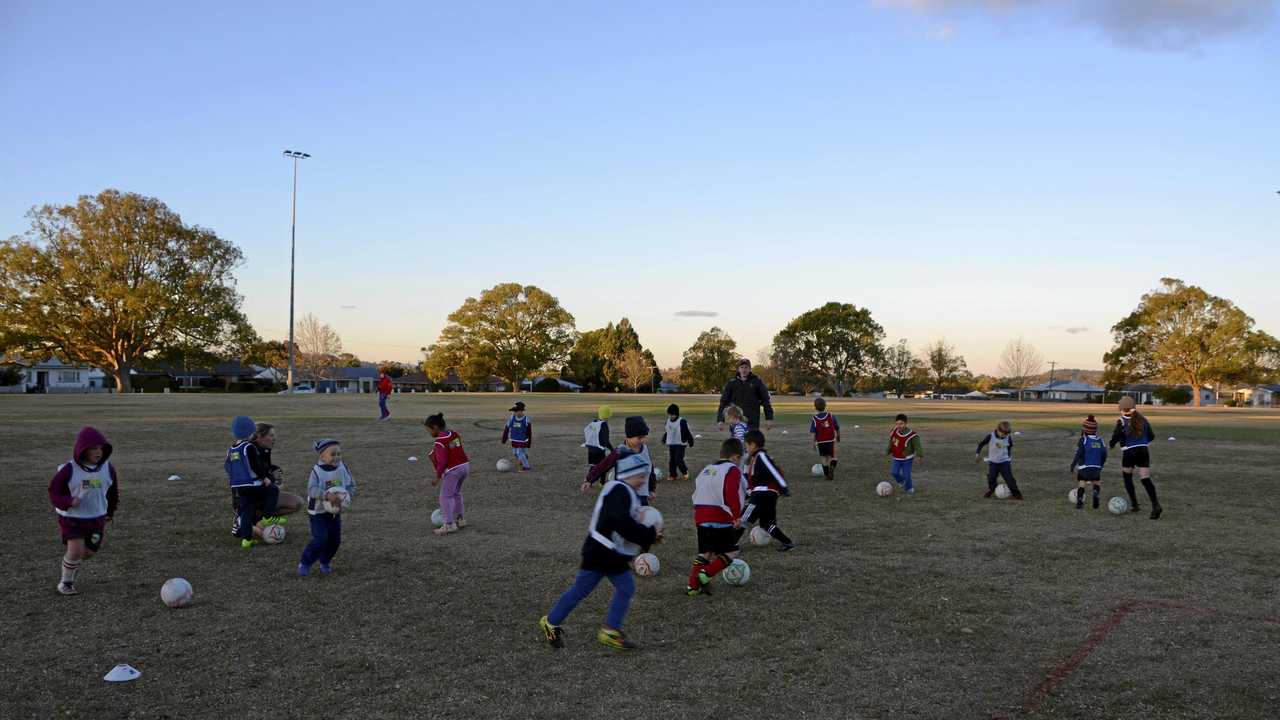 KEEN KIDS Football Queensland Aldi Miniroos development officer Andy Allan leads young players through an exercise. Picture: Jason Gibbs