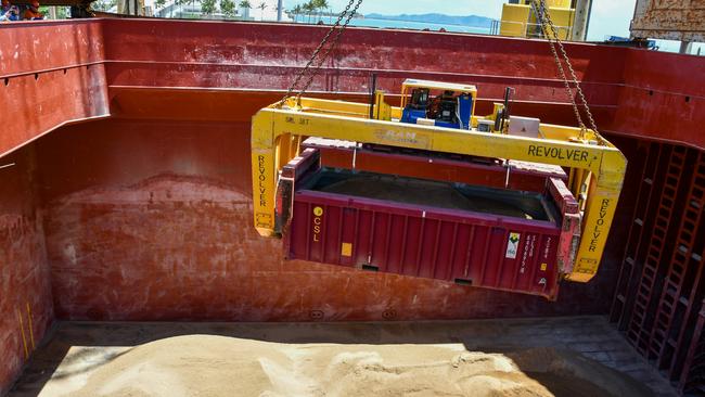 Phosphate rock being loaded in Townsville. Because Centrex was a junior miner and hadn’t constructed its own berth and conveyor belt at the Port of Townsville yet, they were forced to transport their phosphate in “half-height” carriages that the port’s crane can lift and “shake out” over ship cargo bays. The half-height carriages meant Centrex was having to pay more to transport less on the railway, and also pay more at the port due to the slower nature of the shake out method. Picture: Port of Townsville