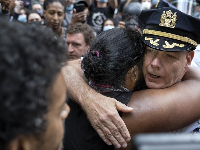 Terence Monahan, hugs an activist after his emotional speech. Picture: AP