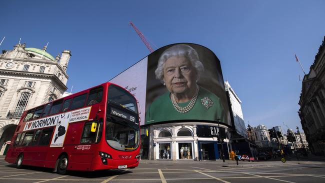 Queen Elizabeth II and quotes from her broadcast to the nation in relation to the coronavirus epidemic are displayed on screens in Piccadilly Circus.