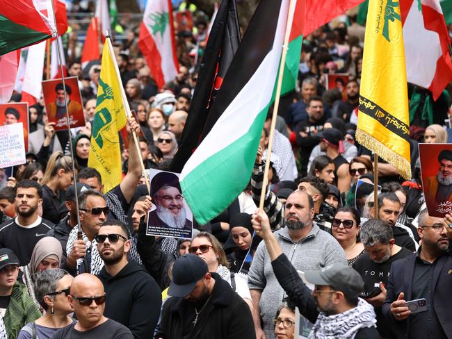 The yellow Hezbollah flag and pictures of Hezbollah leader Hassan Nasrallah at a protest in Sydney. Picture: NewsWire/Damian Shaw