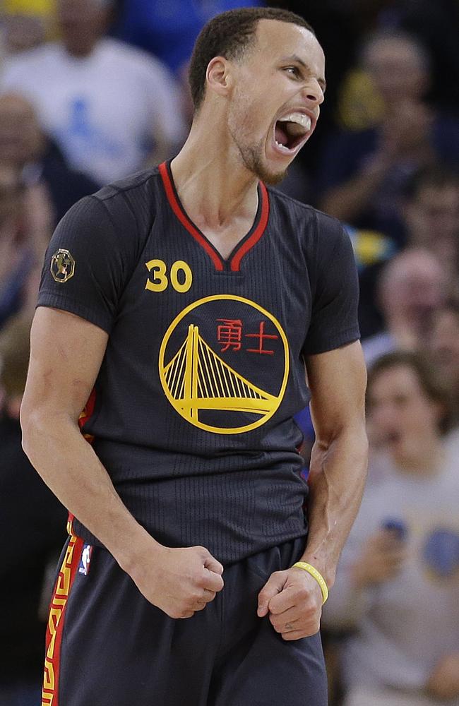 Golden State Warriors star Stephen Curry celebrates as his team takes a lead over the San Antonio Spurs