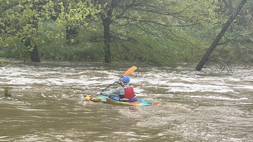 Despite many warnings to stay out of floodwaters a kayaker was spotted riding Riddells Creek through Wybejong Park in the Macedon Ranges. Picture by Adam Daunt.