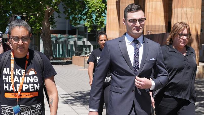 Brandon Chesney, centre, leaves court accompanied by supporters. Picture: Dean Martin