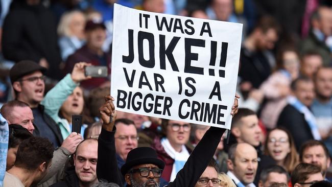 A fan in England with a sign criticising the new VAR system which is also set to be used in the A-League