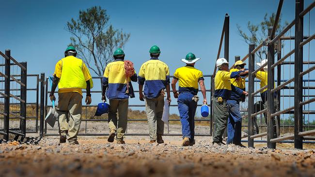 Prisoners help build the cattle yards at the AACo abattoir in 2014.