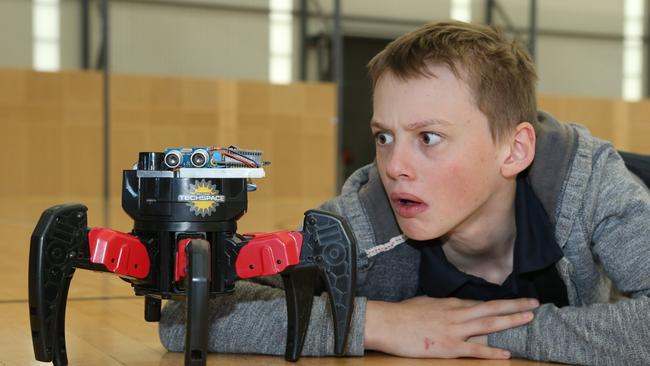 Jaron Dalton, 12, from Parkwood with the Arachnabot from GC Techspace. Picture: Glenn Hampson