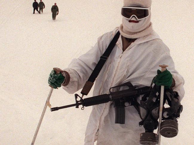 An Israeli soldier from the Alpine unit skis down a mountainside carrying his M-16 (M16) and two gas masks as he joins other members of his unit during an exercise on Mount (Mt) Hermon in on the Golan Heights, 11/02/98. Israel / Armed Forces / Army