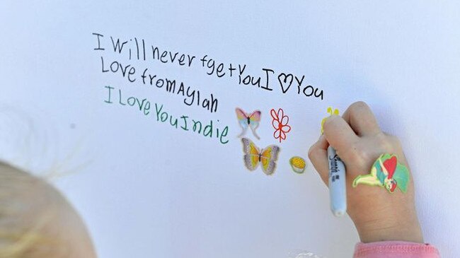 Flowers and messages have been left by Leonie Gilbertson and her daughter Aylah, 6, to pay their respects to the family of the little girl who died in Nambour afterbeing struck by a car on a pedestrian crossing. Picture: Patrick Woods