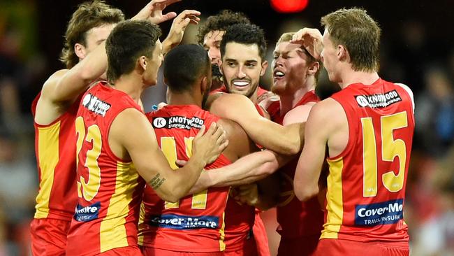 Brayden Fiorini celebrates kicking a goal with teammates. Picture: AFL Photos/Getty Images