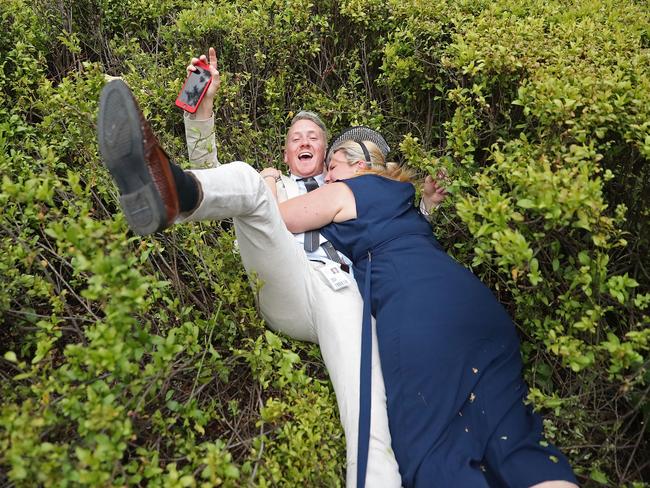 Racegoers fumble in the bushes during Cup Day. Picture: Scott Barbour/Getty Images