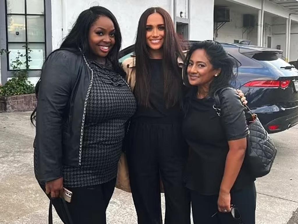 Meghan Markle poses with Kasiopia Moore, left, and an unnamed woman in a picture on Ms Moore’s Instagram account. Picture: Instagram