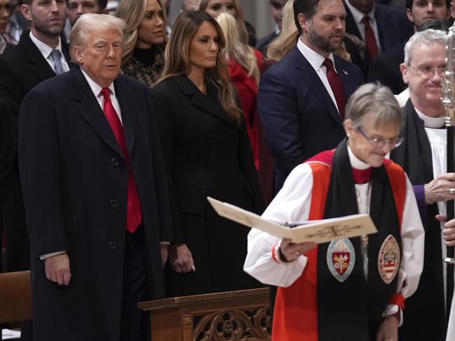 President Donald Trump, left, watches as Rev. Mariann Budde, second right, arrives at the national prayer service at the Washington National Cathedral, Tuesday, Jan. 21, 2025, in Washington. (AP Photo/Evan Vucci)