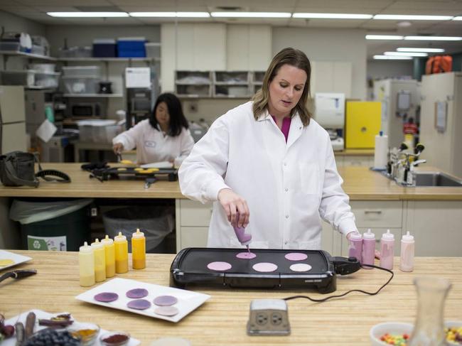 Kate Gallager, a cereal developer at General Mills, puts naturally colored pancake batter onto a griddle to see how it reacts to heat. PHOTO: ACKERMAN + GRUBER FOR THE WALL STREET JOURNAL