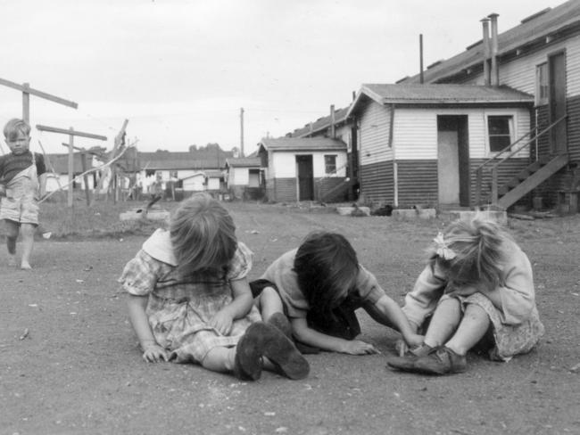 Kids playing in the dirt at Camp Pell in 1954, which served as accommodation for the needy when Melbourne’s slums were closed down in the 1950s. Picture: HWT Library.