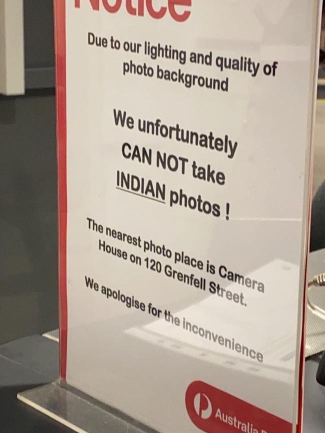 A sign at the City Cross Australia Post indicating they cant do passport photos for Indian people. Picture: @justadelaidethings