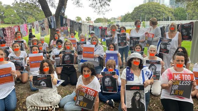 Attendees wear orange tape over their mouths to signify the silence around female hostages. Picture: Supplied