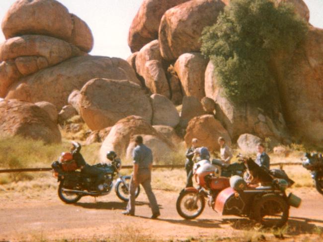 Tim Thomson, Karen Edwards and Gordon Twaddle with dog Tristie at the Devils Marbles.