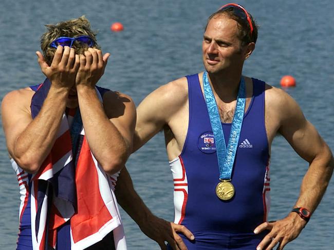 Sir Steve Redgrave, pictured with coxless pairs teammate James Cracknell, managed to avoid the bullet and win a fifth gold at the Sydney Olympics. Picture: Patrick Hamilton