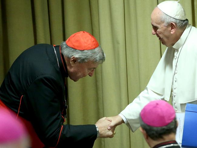 Pope Francis greets Cardinal George Pell in 2015. Picture: Franco Origlia/Getty Images