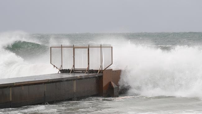 Witnesses saws the man struggling to control his board in the big surf before he was swept against the southern side of the large concrete stormwater drain at Collaroy Beach. He was under water for at least two minutes. Picture John Grainger