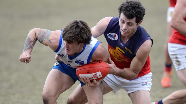 Sunbury Kangaroos' Dylan Murphy tries to get a handball away against Diggers Rest earlier this season. Photo: Angie Basdekis