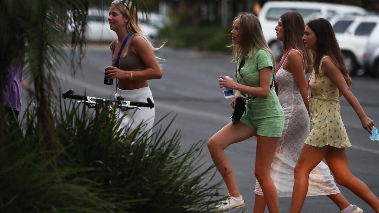 Groups of school leavers cross Johnson St in Byron Bay for 2021 Schoolies celebrations. Picture: Jason O'Brien