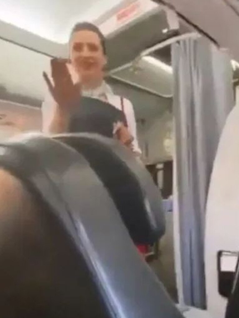 A flight attendant intervenes. Picture: Passenger Shaming