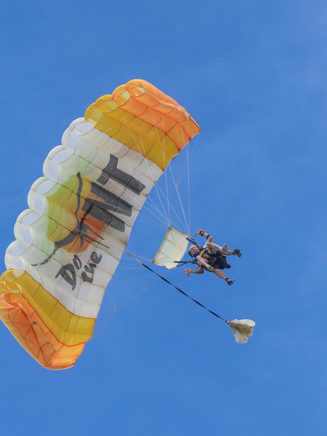 90-year-old skydiver Don Lockley and Tandem Instructor Ashley Smith land on Lee Point. Picture: Glenn Campbell