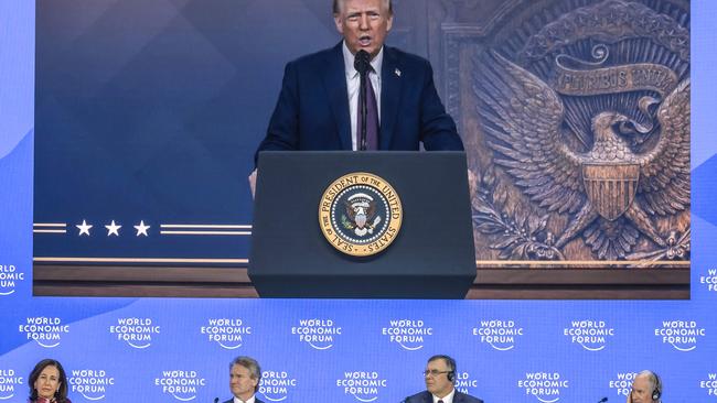 US president Donald Trump appears on a giant screen as he addresses Donald Trump global elites via video conference at the World Economic Forum in Davos on January 23, 2025. (Photo by Fabrice COFFRINI / AFP)