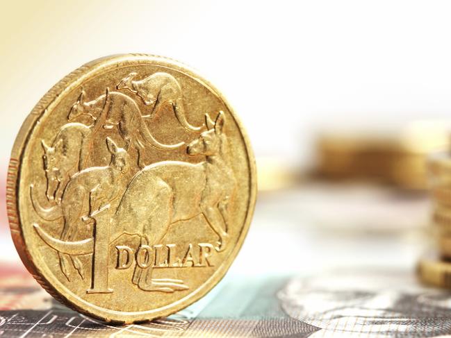 Generic photo of an Australian dollar coin .. Aussie one dollar coins, on a twenty dollar note.