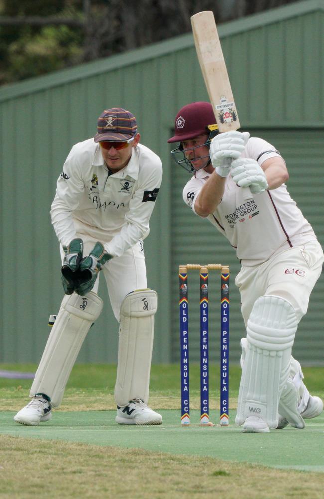 Harry Gouldstone drives for Red Hill as Old Peninsula keep Tom La Brooy looks on. Picture: Valeriu Campan