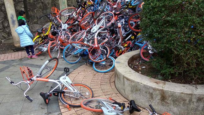 More than 500 bicycles from China's flourishing bike-sharing companies have been dumped in huge piles on the streets of the southern city of Shenzhen, reports said. Picture: AFP/STR/China OUT