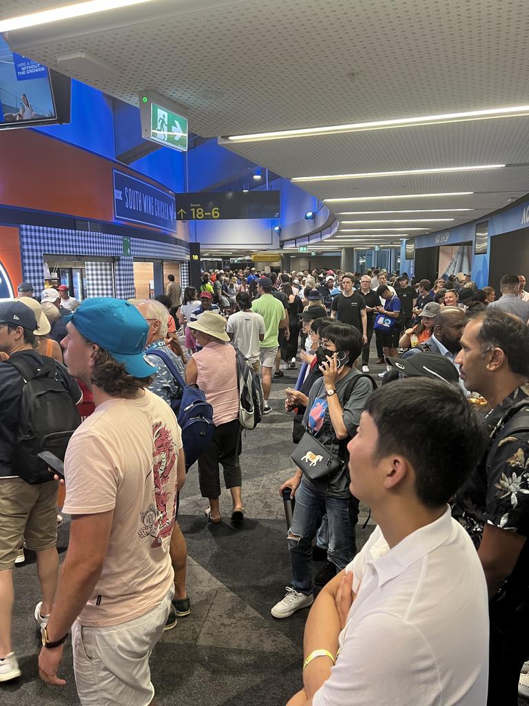 Frustrated tennis fans watch Novak Djokovic and Taylor Fritz play on the TV screens outside Rod Laver Arena. Picture: news.com.au